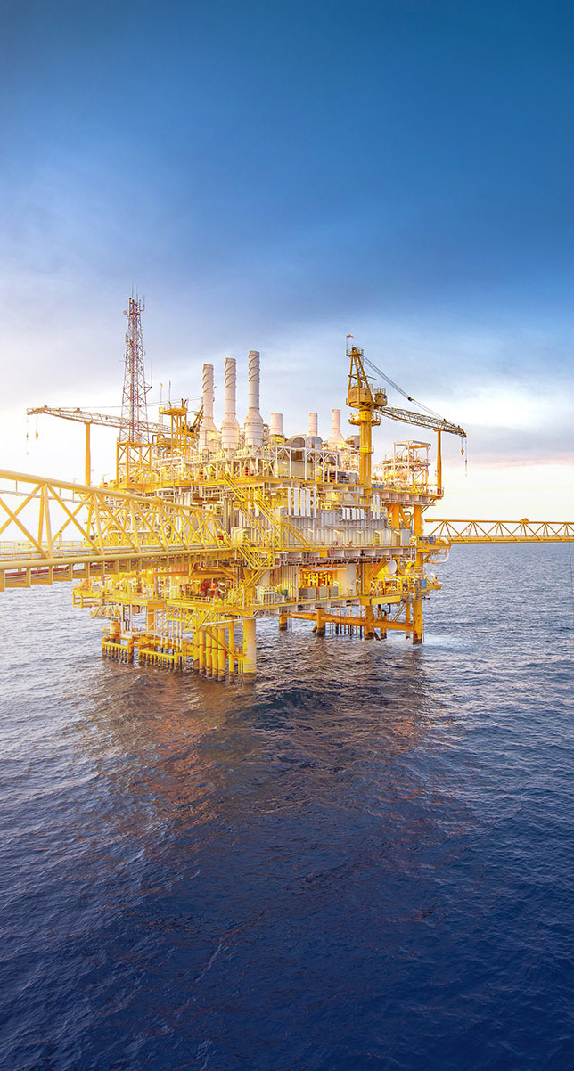 Large offshore drilling oil rig plant in the gulf at twilight